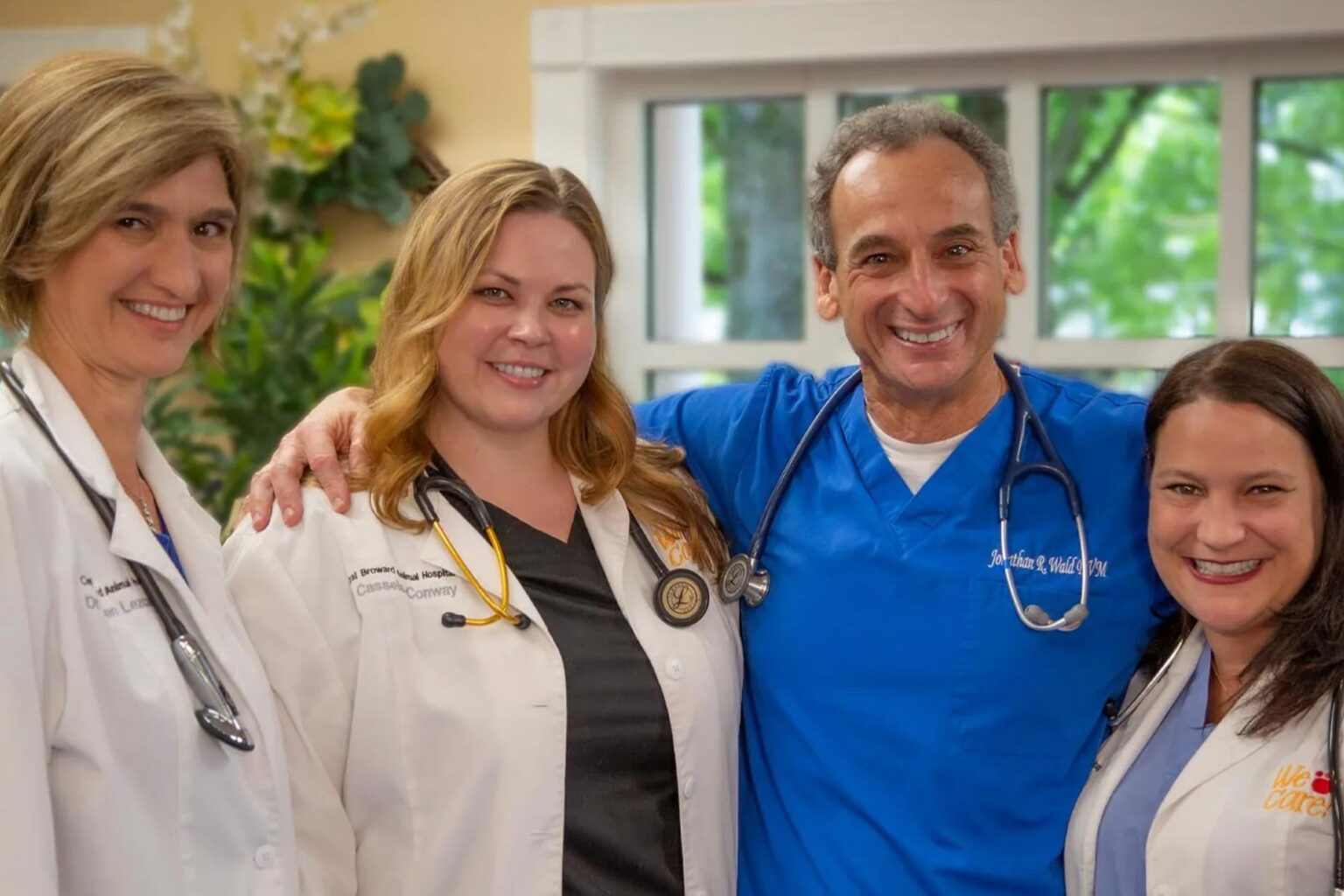 Dr. Jonathan Wald with fellow Central Broward Animal Hospital veterinarians smiling together in the lobby