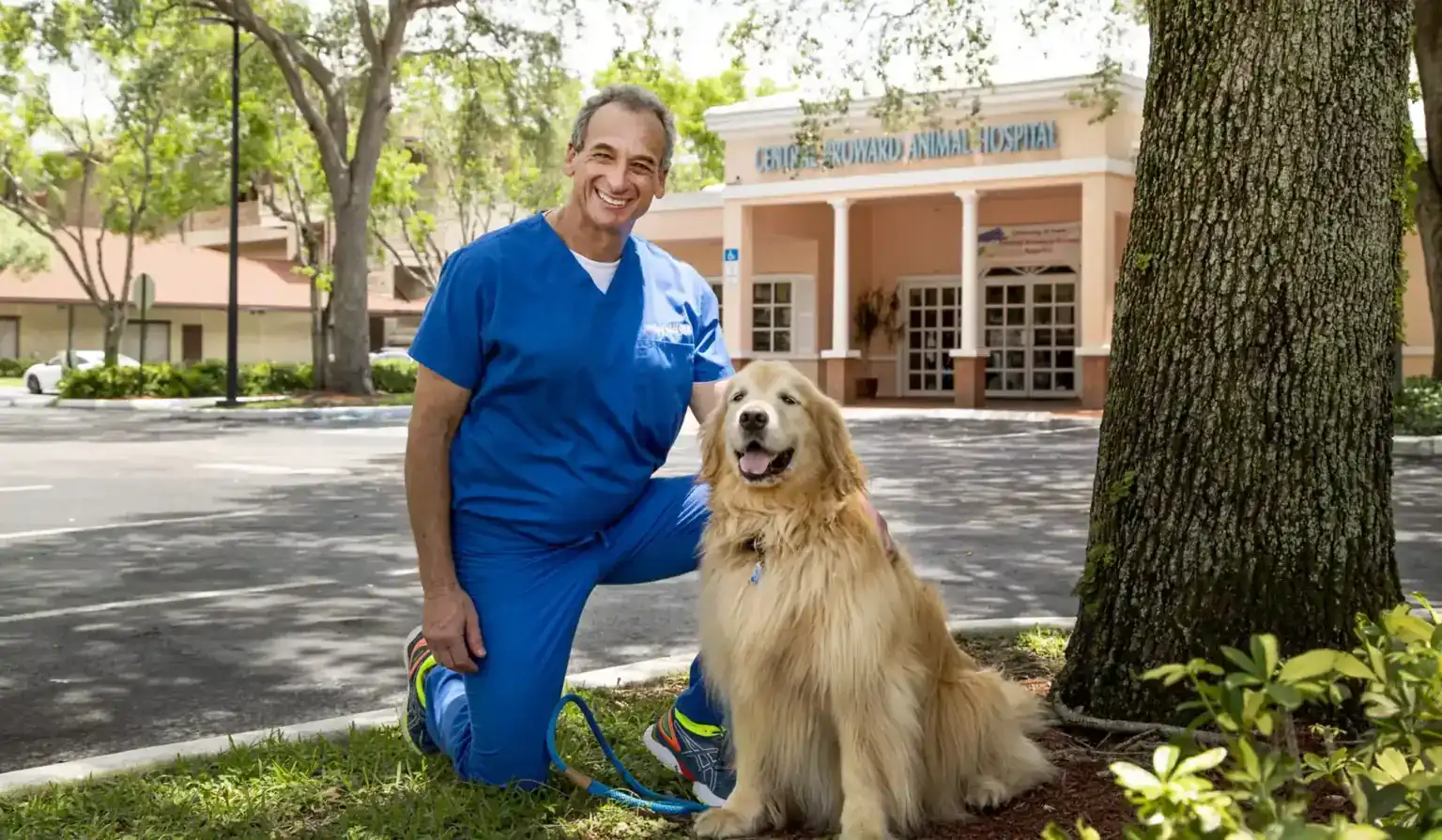 Dr. Jonathan Wald with a golden retriever outside Central Broward Animal Hospital in Plantation